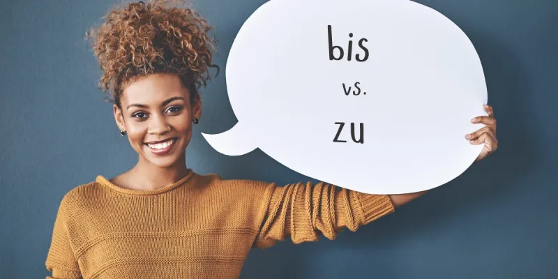 Woman holding a speech bubble showing bis versus zu in German grammar.