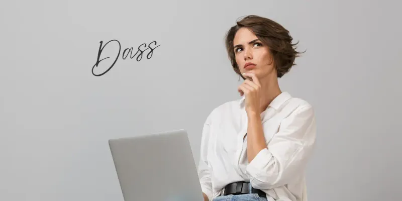 Woman at a laptop thinking about how to use dass in German.