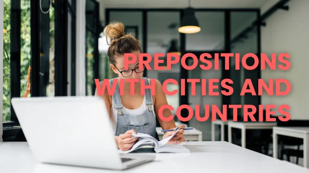 Woman studying at a laptop while learning French prepositions with cities and countries.