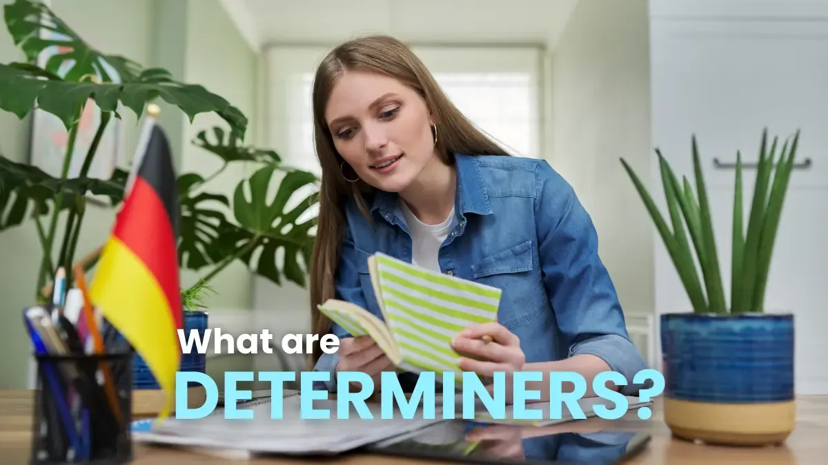 Woman studying with a German flag and notebook, learning what determiners are in German grammar.