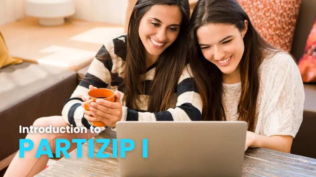 Two smiling young women sitting on a couch, looking at a laptop and learning about German grammar concepts related to participles (partizip I). One woman is holding a mug.