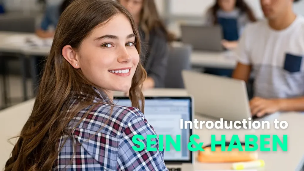 Smiling girl in a plaid shirt at a classroom with a laptop, getting introduced to the German verbs 'sein' and 'haben'.