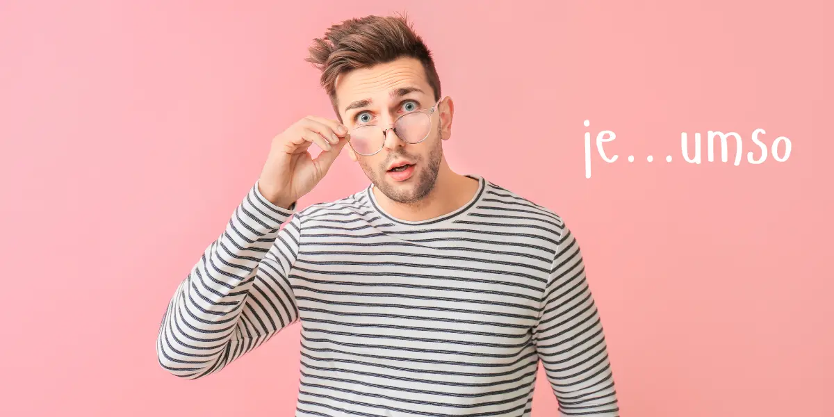 A man adjusts his glasses with a surprised look, trying to master the correct use of 'je...umso' in German grammar.